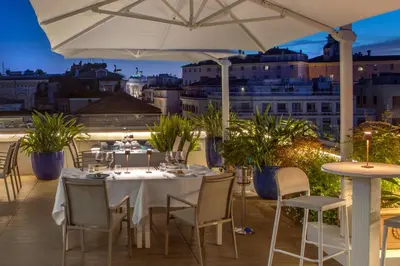 a restaurant with a table and chairs and an umbrella at The Glam in Rome