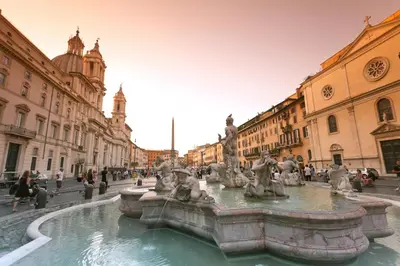 a fountain in the middle of a street with buildings at Ciao Bella Stella in Rome