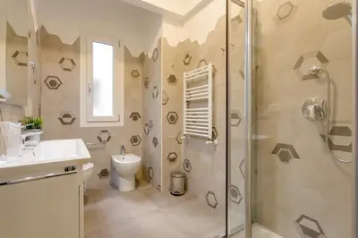 a bathroom with a shower and a toilet and a sink at Franca's Home in Rome
