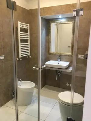 a bathroom with a shower and a toilet and a sink at Roma Veneto Relais in Rome
