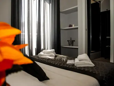 a hotel room with a bed with towels on it at Roma Veneto Relais in Rome