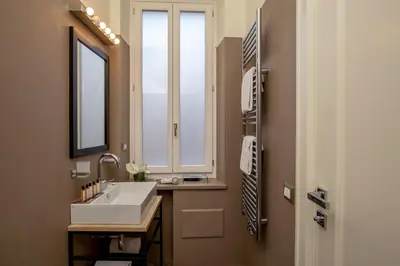 a bathroom with a sink and a window at My Trevi Charming & Luxury Rooms in Rome