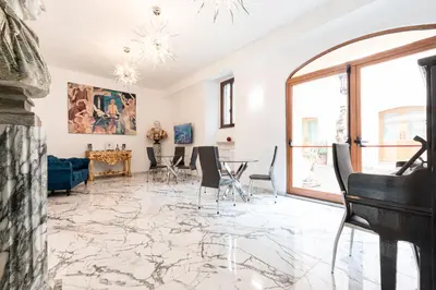 a living room with a marble floor and a piano at Il Monastero Collection in Rome