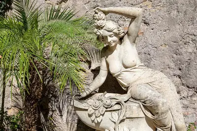 a statue of a woman sitting on a bird bath at Il Monastero Collection in Rome