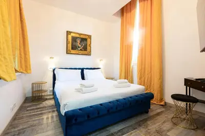 a bedroom with a large bed with a blue frame at Il Monastero Collection in Rome