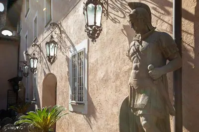 a statue of a man standing next to a building at Il Monastero Collection in Rome