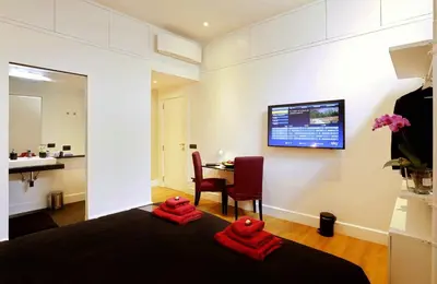 a bedroom with two red towels on a bed at Sant'Angelo Exclusive Spacious Art in Rome