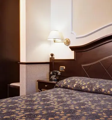 a hotel room with a bed and a telephone at Hotel Best Roma in Rome