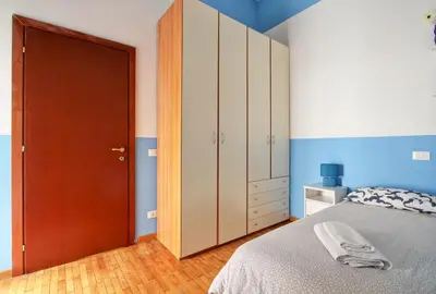 a bedroom with a bed and a wooden door at Roman House in Rome