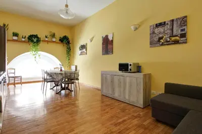 a living room with a table and a dining room at Roman House in Rome