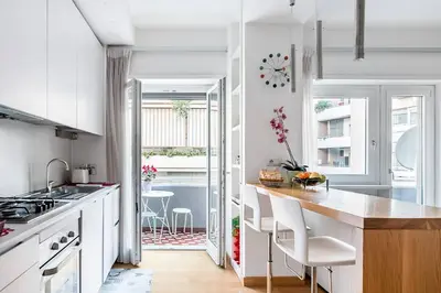 a living room with a white couch with colorful pillows at Residenza San Pio V in Rome