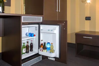 an open refrigerator filled with drinks in a kitchen at AS Planet in Rome