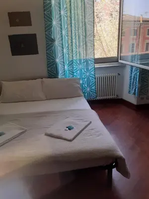 a bed with a towel on it in a room at Happy Rome in Rome