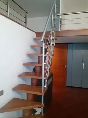 a spiral staircase in a house with wooden floors at Happy Rome in Rome