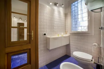 a bathroom with a toilet and a sink at River View Apartment in Rome