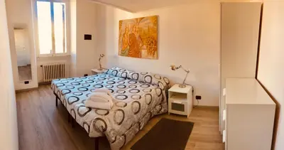 a bedroom with a bed with a blue and white comforter at Heart of Rome Vatican Deluxe New Apartment 1GB WiFi in Rome