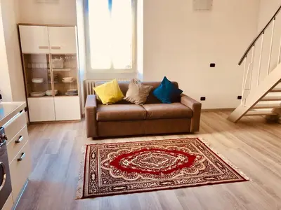 a living room with a couch and a rug at Heart of Rome Vatican Deluxe New Apartment 1GB WiFi in Rome