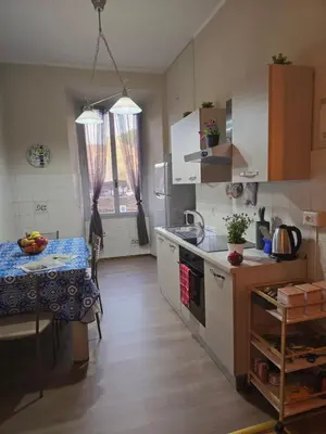 a living room with a flat screen tv on a wall at Casa Tua a Porta Maggiore in Rome