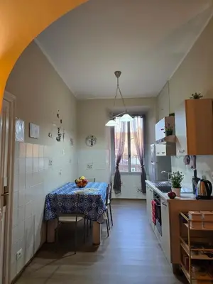 a kitchen with a table and a counter top at Casa Tua a Porta Maggiore in Rome
