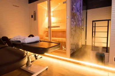a white bathroom with a toilet and a sink at Roma Luxus Hotel in Rome