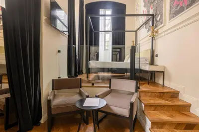 a white bathroom with a sink and a toilet at Roma Luxus Hotel in Rome