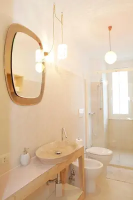 a bathroom with a sink and a toilet and a mirror at Testaccio Old Rome Apartment in Rome