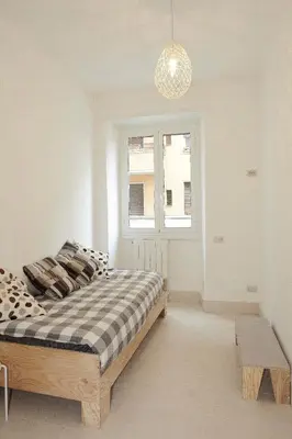 a bedroom with a bed and a window at Testaccio Old Rome Apartment in Rome