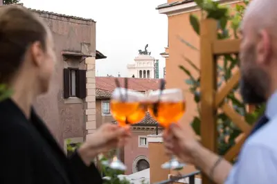 two people holding up glasses of wine at Hotel Monte Cenci in Rome