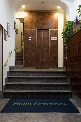 a hotel entrance with a door and stairs with a welcome mat at Hotel Stromboli in Rome