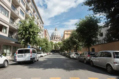 a street with cars parked on the side of the road at B&B Fantasie Romane in Rome