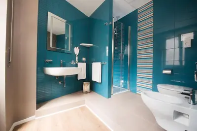 a bathroom with blue walls and a sink and a toilet at B&B Fantasie Romane in Rome