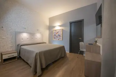 a bedroom with a bed and a table and a chair at B&B Fantasie Romane in Rome