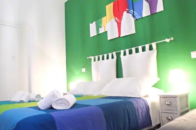 a green bedroom with a bed with towels on it at Like Family House in Rome