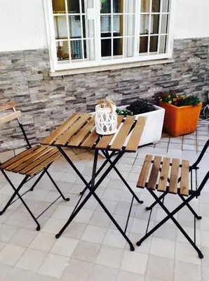 a picnic table and two chairs on a patio at Like Family House in Rome