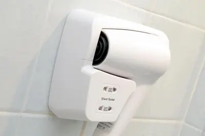 a white toilet paper dispenser on a wall at Holiday rental San Lorenzo district in Rome