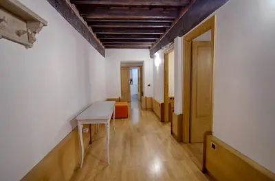 an empty room with a table and an orange couch at Rinidia - Roma Centro in Rome