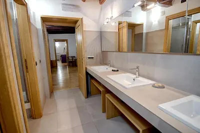 a bathroom with two sinks and a large mirror at Rinidia - Roma Centro in Rome
