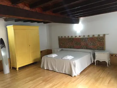 a bedroom with a bed and a yellow cabinet at Rinidia - Roma Centro in Rome