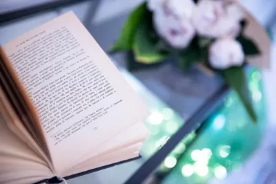 a book on a table with a vase of flowers at Interno 6 San Pietro in Rome