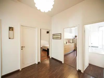 an empty room with white walls and wooden floors at Roman Home Base in the Appio Latino in Rome