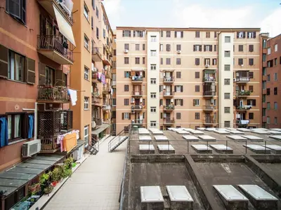 an empty street in a city with buildings at Roman Home Base in the Appio Latino in Rome
