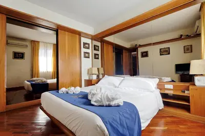 a bedroom with a large bed with towels on it at Frattina Family Romantic Superior Suite in Rome