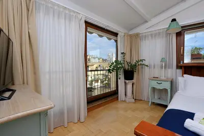 a bedroom with a bed and a large window at Frattina Family Romantic Superior Suite in Rome