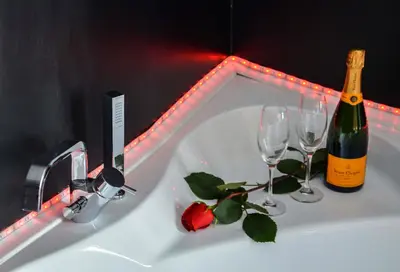 a bottle of champagne and two wine glasses on a sink at Good Life Via Veneto in Rome