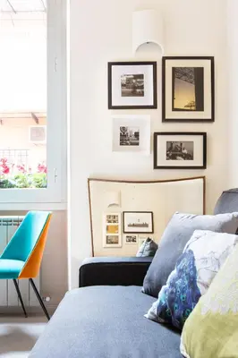 a bedroom with two beds and a blue chair at Dandy Suite in Rome