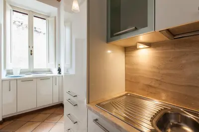 a kitchen with a sink and a window at A Window on Pantheon in Rome