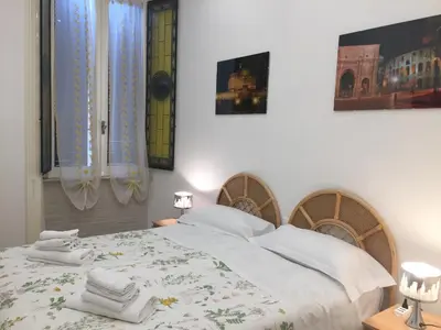 a bedroom with a bed with towels on it at Sweet Roman Dream in Rome