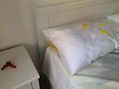 a bed with a white pillow with flowers on it at Sweet Roman Dream in Rome