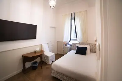 a hotel room with a bed and a flat screen tv at Relais Donna Lucrezia in Rome