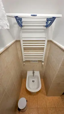a bathroom with a toilet and a sink at Alfieri home holiday in Rome